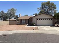 Charming home with desert landscaping, a two-car garage, and mature trees at 4927 W Golden Ln, Glendale, AZ 85302