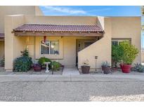 Charming home featuring a red tile roof, cozy front porch, and desert landscaping at 5848 W Gelding Dr, Glendale, AZ 85306