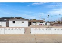 Charming single-story home featuring a tidy front yard, decorative block wall and xeriscaping at 8556 E Pecos Ln, Scottsdale, AZ 85250