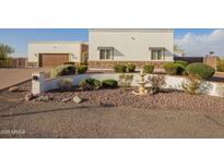 Charming exterior showcasing a well-maintained lawn, a lovely water fountain and beautiful desert landscaping at 10328 W Villa Linda Dr, Peoria, AZ 85383