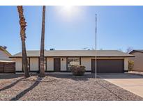 Charming single-story home with a gravel front yard and attached garage at 10533 W Lawrence Ln, Peoria, AZ 85345
