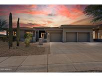 Stunning desert home with three car garage and mature landscaping in the front yard at 10951 E Mirasol Cir, Scottsdale, AZ 85255