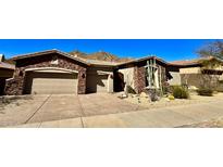 Charming desert home with stone accents, a two-car garage, and low-maintenance landscaping at 12770 N 145Th Way, Scottsdale, AZ 85259