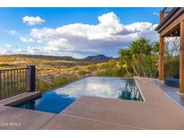 Stunning infinity pool with desert views and lush landscaping create a serene outdoor oasis at 14426 N Vista Del Oro --, Scottsdale, AZ 85264
