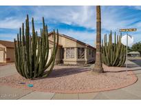 Desert landscaping complements this corner lot house, enhancing the curb appeal at 15002 W Heritage Oak Way, Surprise, AZ 85374