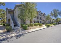 Exterior view of a two-story building with sidewalks and lush landscaping, offering a welcoming curb appeal at 15095 N Thompson Peak Pkwy # 1053, Scottsdale, AZ 85260