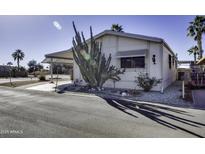 Charming single-story home featuring a covered carport and xeriscaped landscaping with a large cactus at 17200 W Bell Rd # 1551, Surprise, AZ 85374