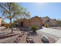 Charming single-Gathering home featuring desert landscaping, a two-car garage, and neutral stucco exterior at 22583 W Lasso Ln, Buckeye, AZ 85326