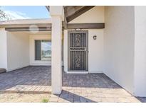 Inviting front porch with brick pavers and decorative security door detail at 4702 N 87Th Ave, Phoenix, AZ 85037