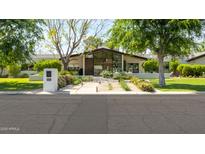 Beautifully landscaped front yard and modern home exterior with large windows at 6301 E Exeter Blvd, Scottsdale, AZ 85251