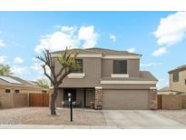 Charming two-story home with neutral exterior, two-car garage, and low maintenance desert landscaping at 743 E Dragon Springs Dr, Casa Grande, AZ 85122