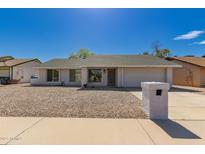 Charming single-story home featuring low-maintenance landscaping and a classic desert aesthetic at 1409 W Monona Dr, Phoenix, AZ 85027