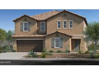 Charming two-story home featuring a tan stucco exterior, shuttered windows, attached two-car garage and desert landscaping at 17166 W Oberlin Way, Surprise, AZ 85387