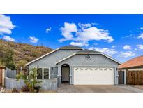 Charming single-story home with a two-car garage and desert landscaping under a bright blue, cloudy sky at 1723 E Behrend Dr, Phoenix, AZ 85024