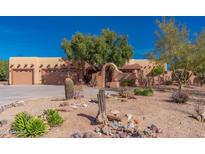 Charming desert home with a three-car garage and mature trees and low water landscaping at 2070 W Bromm Ln, Wickenburg, AZ 85390