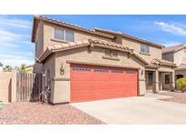 An exterior view showcases the home's red two-car garage door and driveway at 2190 W San Tan Hills Dr, San Tan Valley, AZ 85144