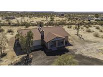 A beautiful, cozy home with a red tile roof sits on a large lot at 27141 E Javelina Dr, Florence, AZ 85132