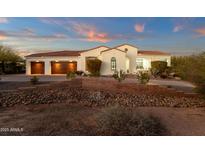 Elegant single-story home with a three-car garage, desert landscaping, and a beautiful red tile roof at 28714 N Verde River Way, Rio Verde, AZ 85263