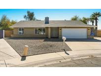 Charming single-story home featuring a brick facade, well-maintained yard, and a two-car garage at 3223 W Purdue Ave, Phoenix, AZ 85051