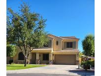 Charming two-story home featuring a well-maintained front yard, manicured lawn, and a two-car garage at 4529 S Granite St, Gilbert, AZ 85297