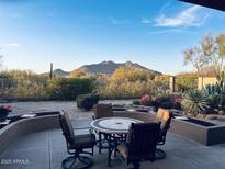 Outdoor patio featuring a charming table set with a scenic view of the desert landscape and mountains at 6998 E Soaring Eagle Way, Scottsdale, AZ 85266