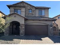 Charming two-story home featuring stone accents, a tile roof, and a two-car garage at 7253 E Nathan St, Mesa, AZ 85207