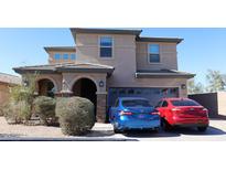 Two-story home featuring stacked stone accents, a two-car garage, and a tile roof at 8420 S 40Th Dr, Laveen, AZ 85339