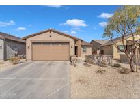 Charming single-story home featuring a well-maintained front yard and a two-car garage at 9008 W Bethany Heights Dr, Glendale, AZ 85305