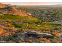 Expansive luxury home with desert landscaping and golf course views, set against a mountain backdrop at 9820 E Thompson Peak Pkwy # 629, Scottsdale, AZ 85255