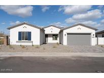 Charming single-story home featuring a three-car garage and low maintenance desert landscaping at 9907 S 37Th Dr, Laveen, AZ 85339