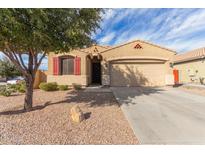 Charming single-story home with a well-maintained yard, desert landscaping, and red shutters at 1380 W Angus Rd, San Tan Valley, AZ 85143