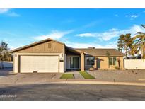 Charming single-story home with a well-manicured front yard and attached two-car garage at 1411 S Glenview --, Mesa, AZ 85204