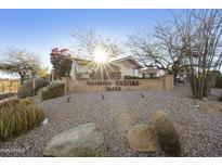 Welcoming Wahinda Casitas entrance sign surrounded by desert landscaping and mature trees at 16615 E Gunsight Dr # 205, Fountain Hills, AZ 85268