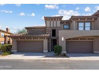 Inviting two-story condo with stone accents, tile roof, and two-car garage at 19700 N 76Th St # 2169, Scottsdale, AZ 85255
