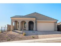 Charming single-story home featuring a neutral palette, arched entryway, and low maintenance landscaping at 31672 N 135Th Ln, Peoria, AZ 85383