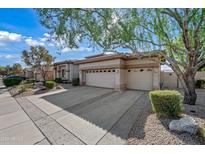 Charming home featuring a wide driveway, manicured landscaping, and a convenient two-car garage at 4503 E Robin Ln, Phoenix, AZ 85050