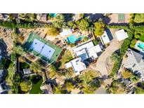 Expansive estate with private pool, tennis court, mature landscaping, and impressive architecture at 6336 N 48Th Pl, Paradise Valley, AZ 85253