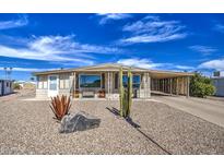 Charming home with low maintenance desert landscaping, covered parking, and ample curb appeal at 7408 E Bosaga Way, Mesa, AZ 85208