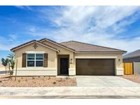 Charming single-story home with a two-car garage, brown shutters, and well-maintained landscaping at 8534 W Mantle Way, Florence, AZ 85132