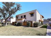 Charming two-story condo featuring stucco exterior, tasteful landscaping, and tile roof accents at 8819 N 12Th Pl, Phoenix, AZ 85020