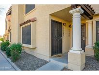 Inviting front entrance with decorative pillars and a secure gate, enhancing curb appeal and security at 921 W University Dr # 1143, Mesa, AZ 85201
