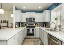 Well-equipped kitchen featuring white cabinets, stainless steel appliances, and stylish backsplash at 921 W University Dr # 1143, Mesa, AZ 85201