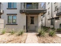 Inviting two-story townhome with desert landscaping, a private balcony, and a covered entry at 2090 S Dorsey Ln # 1020, Tempe, AZ 85282