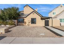 Charming single-story home featuring a well-maintained exterior with black trim windows, complemented by a low maintenance yard at 2138 W Beaubien Dr, Phoenix, AZ 85027
