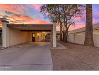 Charming single-story home with covered parking and a well-maintained yard at sunset at 2966 S Country Club Way, Tempe, AZ 85282