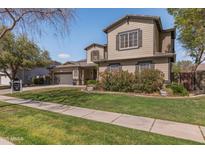 Charming two-story home featuring desert landscaping, a well-manicured lawn, and a two-car garage in a tranquil neighborhood at 3062 E Cullumber St, Gilbert, AZ 85234