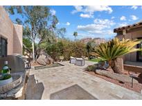 Charming backyard featuring a stone patio, water feature, lush landscaping, and comfortable seating area, perfect for outdoor relaxation at 4448 E Camelback Rd # 16, Phoenix, AZ 85018