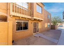 Two-story condo featuring a secure entryway and a small, private balcony at 4615 E Southgate Ave, Phoenix, AZ 85040