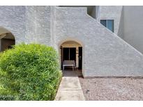 Inviting entrance features an arched doorway and a bench for relaxing outdoors at 4730 W Northern Ave # 1102, Glendale, AZ 85301