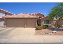 Inviting single-Gathering home featuring a well-manicured front yard and a spacious three-car garage at 5102 E Libby St, Scottsdale, AZ 85254